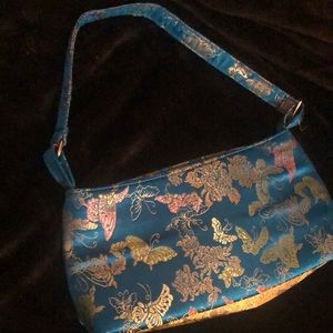 bag is blue with butterfly's and flowers